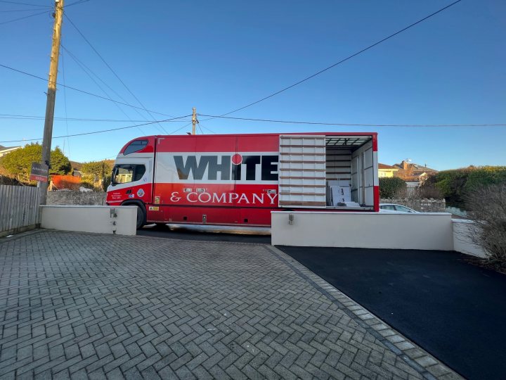 A red and white bus parked in front of a building - Pistonheads