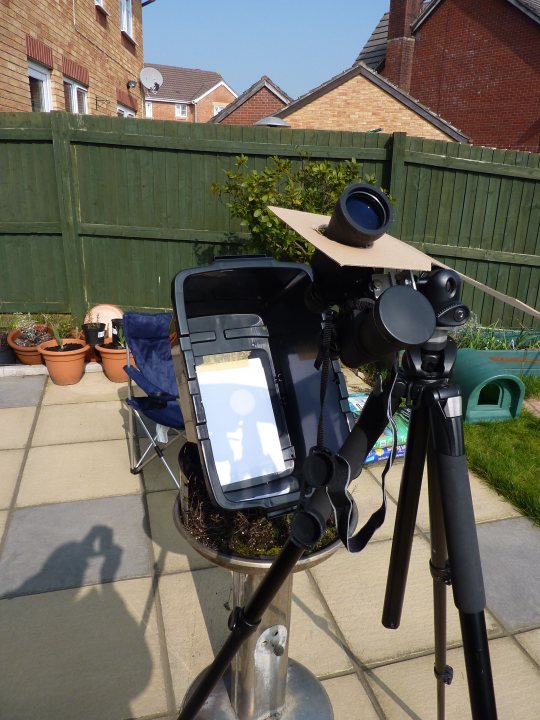 A bike parked next to a parking meter - Pistonheads - In the image, an innovative setup is captured where a tripod, complete with a camera and a screen, is placed on top of a stand. The tripod, which is black, lifts the screen and the camera, suggesting a potential event or live streaming session. The screen in the tripod appears to show a website, possibly with the reflection of a person nearby. 

The stand upon which the tripod is placed has a white paper crown, adding a touch of whimsy to the otherwise professional setup. The background reveals a garden area with a neatly trimmed lawn and a wooden fence, indicating a homely and relaxed environment. The entire setup seems to be awaiting an upcoming event or performance, ready to capture and broadcast it to the audience.