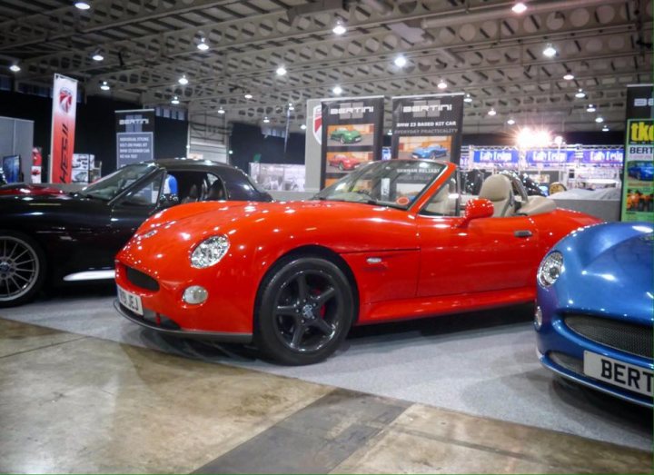 A red and white car is parked in a garage - Pistonheads