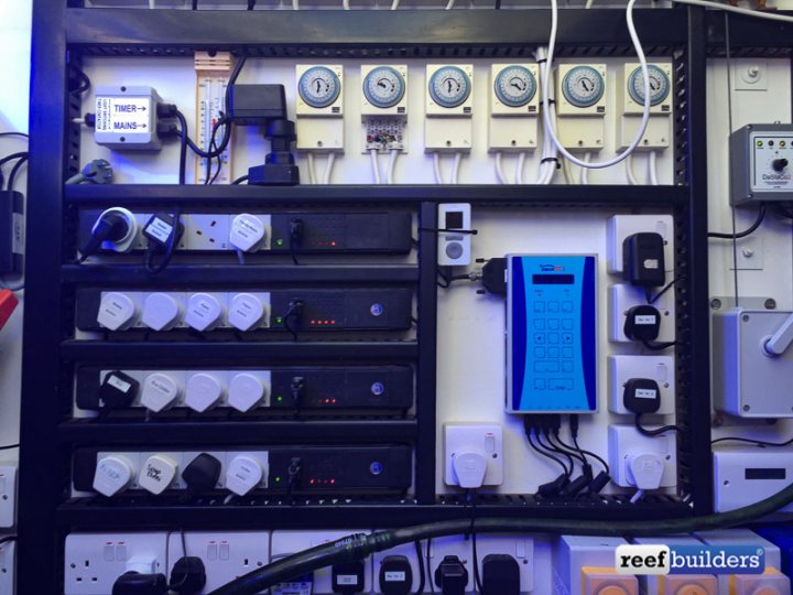 Wiring up 9 double sockets together - Page 3 - Homes, Gardens and DIY - PistonHeads - The image shows a complex control panel with various electronic devices and buttons. There are numerous cables and connectors, suggesting a high level of technological integration. The panel is predominantly black and has several lights on it, indicating active status or some form of monitoring. The word "BUILDERS" is visible in the image, possibly indicating the name of the company or the nature of the work being done with this control panel. The environment suggests an industrial setting, as evidenced by the metal structure of the control panel and the utilitarian appearance of the surroundings.