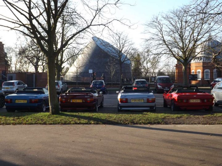 A group of cars driving down a street - Pistonheads