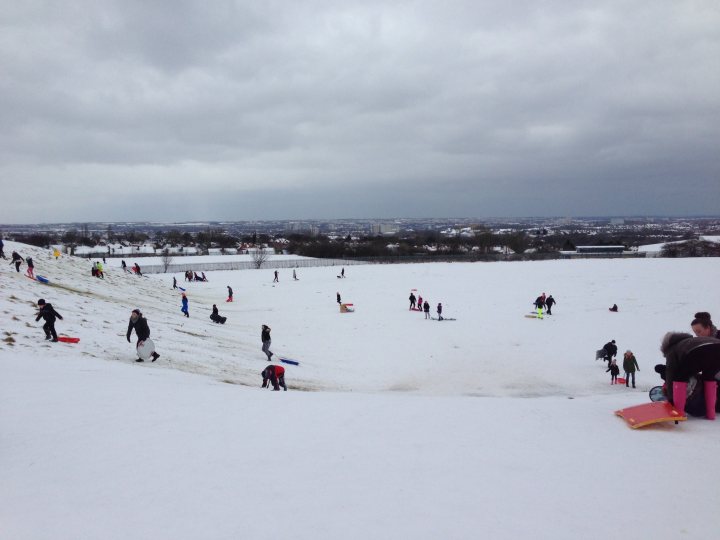 A group of people riding skis down a snow covered slope - Pistonheads