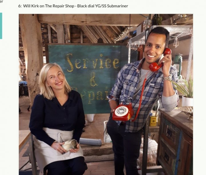 The image displays a screenshot of a website with an article in progress. At the top, there is a blue banner with white text that reads "6 Will Kirk on the Repair Shop." Below this headline, there's a photograph featuring a man and a woman sitting at what appears to be a workbench or shop counter. The man is holding up a cell phone to his ear, while the woman has a laptop in front of her. They seem to be engaged in a conversation or activity.

The background shows a wooden structure with a sign that reads "Service & Repair." There's also a chalkboard behind them with some writing on it. The ambiance suggests they are in an interior space, possibly a workshop or repair shop.