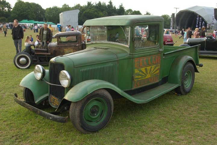 Pistonheads - In the center of the image, a vintage green truck occupies a grassy area, giving off a sense of nostalgia. The truck is not alone, it's parked next to other antique cars, each carefully restored and showcasing the elegance of a bygone era. The setting appears to be an outdoor event or car show, as indicated by the background of tents and people milling about, admiring the vehicles on display. The grass underfoot and the open sky above suggest a bright and sunny day, perfect for this outdoor exposition. The vehicles, coupled with the people, create a vibrant and lively atmosphere, filled with the beauty and intrigue of old-world automobiles.