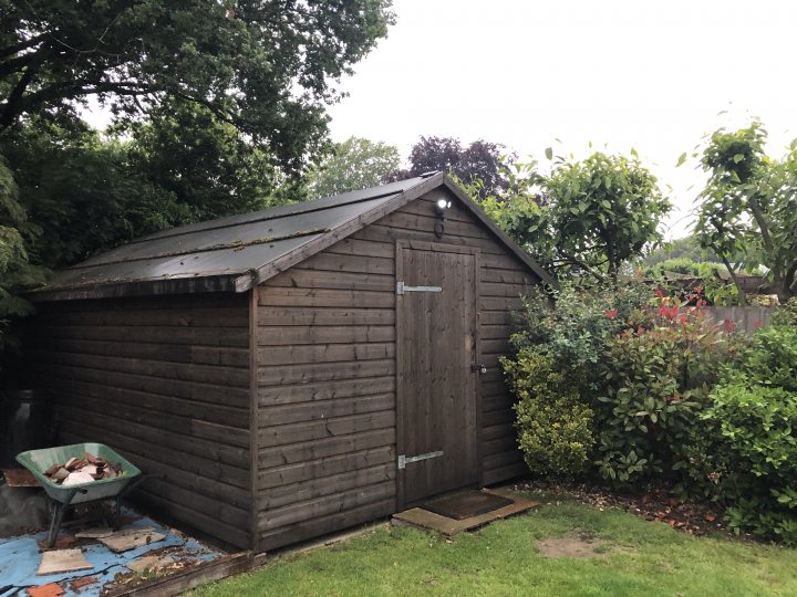 Woodwork 101 - Page 5 - Homes, Gardens and DIY - PistonHeads - The image depicts a garden setting with a wooden shed, which appears to be under construction or renovation. There are various tools and materials visible, suggesting ongoing work on the structure. The shed is situated outdoors in what seems to be a private backyard, and it's adjacent to a neatly maintained lawn area. The surroundings include greenery and other garden elements, implying a peaceful residential environment. There is no visible text in the image to provide additional context or information.