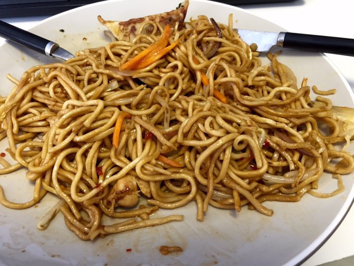 Photo of your Lunch - Page 96 - Food, Drink & Restaurants - PistonHeads - The image showcases a plate filled with a generous serving of lo mein, an egg noodle dish. The noodles are clearly separated, and the plate is filled to its brim. The noodles are mixed with bean sprouts and carrots, suggesting a variety of taste and texture in this dish. The colorful vegetables contrast nicely with the cooked noodles, and a fork is visible nearby, ready to dig into the delicious meal. There's a sense of abundance and warmth conveyed by the platter of lo mein.