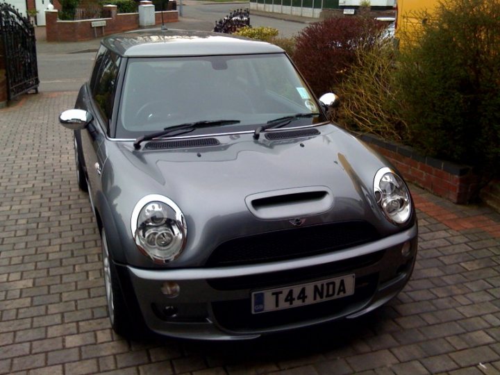 Supercharged fun! - Page 1 - Readers' Cars - PistonHeads - The image shows a small silver car parked on a paved driveway. The car has distinctive headlights and a notable front design. The car features a license plate with the letters "T44 NDA" written on it. The setting includes a section of a brick walkway and a portion of what appears to be a residential street with houses and gardens visible in the background. There are no visible texts on the image.