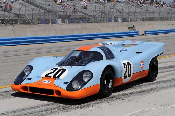 A blue and white car parked on the side of a road - Pistonheads - The image captures a vibrant scene on a Formula 1 track. A striking blue and orange race car, with the number 20 prominently displayed, is in motion. The year '1995' is also evident on the car. This classic racing car is one of several on the track, adding to the dynamic and exciting atmosphere of the event. Spectators line the track, their focus riveted on the speeding vehicles, basking in the thrill and energy of the race.