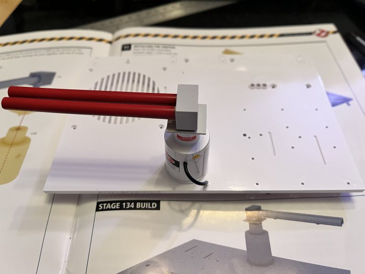 Pistonheads - The image captures a moment of creativity and assembly. Dominating the scene is a whiteboard, serving as the canvas for ideas yet to be implemented. A small robot, perhaps the protagonist of this narrative, stands at attention in front of the board. 

To the right of the robot, an orange screwdriver lies idle, hinting at the recent activity or imminent task. A red pipe extends from the bottom left corner of the image, adding a splash of color to the otherwise monochrome setting. 

In the background, a yellow caution sign stands erect, its vibrant hue contrasting with the whiteboard. It's as if it's keeping a watchful eye on the proceedings, ensuring safety amidst the flurry of creativity and innovation. The entire scene is bathed in a soft light, casting gentle shadows that add depth to the image.