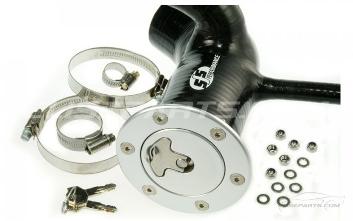 A close up of a pair of scissors - Pistonheads - The image shows a collection of motorcycle parts, including a round aluminum cover with a keylock, isolated on a bright white background. Beside the main part, there are metal sleeves, a couple of cartridges, and several small metal bolts with nuts. The parts appear to be spare or newly purchased, with some disassembled and laid out individually. The focus on spares and the absence of the motorcycle itself suggest this might be for an aftermarket sale or for reference against a damaged or missing part in another context.