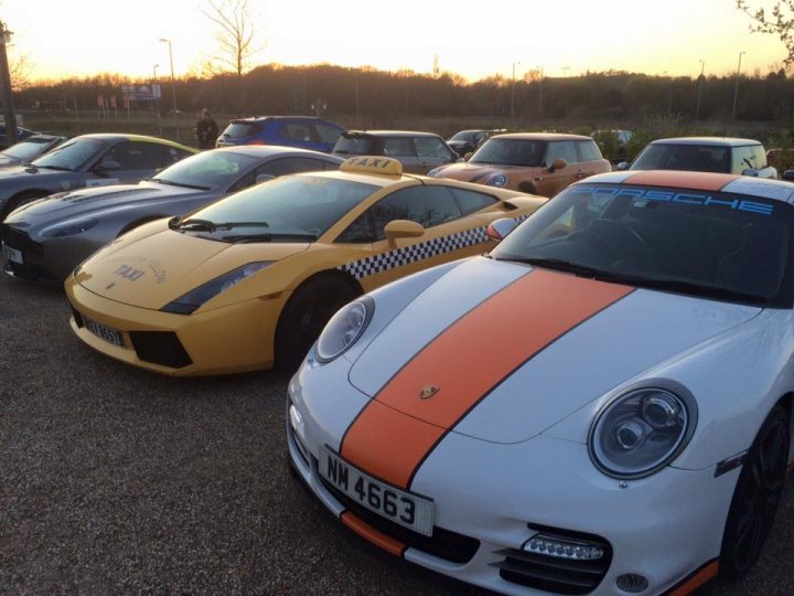 TVR Berkshire + Friends May Meet - Page 1 - Thames Valley & Surrey - PistonHeads - This is a color photograph showing a collection of sports cars parked side by side. The cars vary in color, with a mixture of white, yellow, and silver exteriors. The vehicle on the left foreground has an F35 license plate. The environment suggests a parking lot, and the sky depicts a cloudy sunset. The setting appears to be in what may be a European country, as indicated by the style of the cars and the license plates.