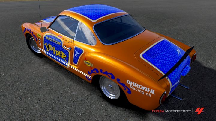 A red car is parked in a parking lot - Pistonheads - In the image, there is a vibrant orange Bardahl racing car parked on a black asphalt surface. The car features a blue aero on its back, and it prominently displays the brand name "Bardahl" on its side and the text "Bardahl Racing Oil" on the back. The setting suggests a racing environment with a dull grey background and a red and white colored structure visible in the background. The image's resolution and detailing indicate it may have been taken with a high-definition camera or through digital media post-processing.