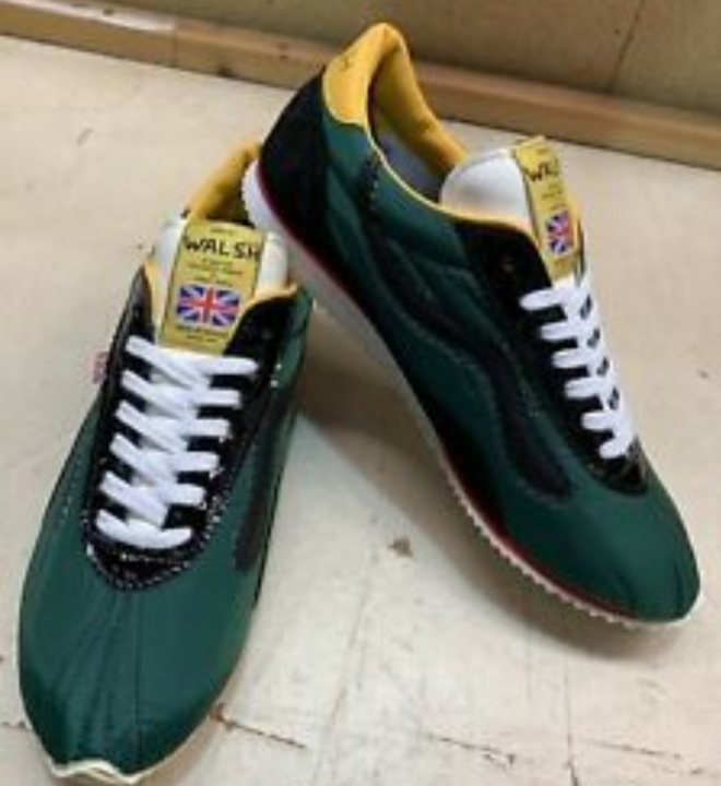 Anyone into trainers/sneakers? (Vol. 2) - Page 222 - The Lounge - PistonHeads - The image displays a pair of sports shoes with a combination of green, yellow, and black colors. They are placed on a flat surface. The top of the left shoe is visible, showing a lace-up design. On the side of one shoe, there's a small union jack flag design. The brand of the shoes appears to be "WALSH," with the UK flag logo on them. There's also some text on the side that reads "UNION JACK." The style of the image is straightforward, focusing solely on the shoes without any additional context or items.