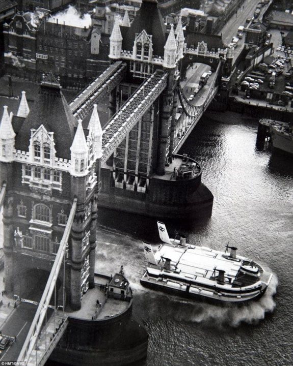 Post amazingly cool pictures of aircraft (Volume 2) - Page 413 - Boats, Planes & Trains - PistonHeads - The image is a black and white photograph capturing a moment in time at the iconic London Bridge. A passenger boat, with its sleek silhouette against the darker background of the Thames River, is seen crossing under the bridge. This boat, slightly larger than the rest, occupies a significant portion of the frame, drawing attention to its journey beneath the historic landmark.

The bridge itself, a testament to Gothic architecture, stands tall on either side of the river. Its intricate design and multiple towers are clearly visible, adding depth and texture to the image. The perspective from which the photo is taken provides a panoramic view of the bridge and the surrounding environment, including the cityscape in the distance.

The Thames River, calm and serene, flows smoothly beneath the boat, its surface mirroring the sky above. The absence of color in this monochrome image enhances the contrast between the white boat and the darker tones of the bridge and river, adding a timeless quality to the scene.