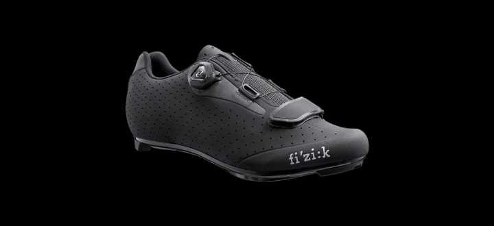 The "what bike bits have you just bought" thread - Page 358 - Pedal Powered - PistonHeads - The image features a single shoe set against a stark black background. The shoe appears to be designed with functionality in mind, possibly intended for running or sports activities given its breathable and durable nature. The brand name "FIZIK" is clearly visible on the shoe, indicating the manufacturer. The shoe's design includes prominent textures and a series of lines that add to its dynamic look. The overall shape of the shoe suggests a modern, sporty style.