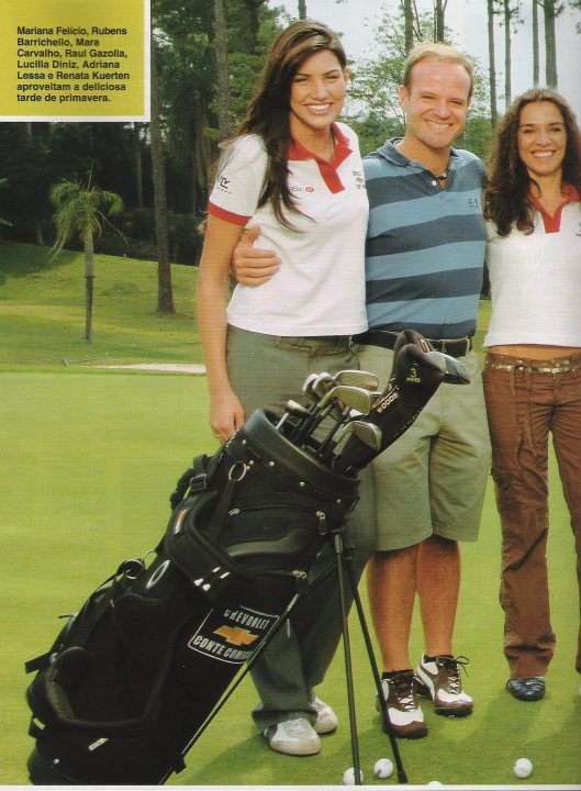 The image is a color photograph featuring a woman and two men on a golf course. They are smiling and posing with their clubs by the golf balls. The woman is on the left, modeling a white and green shirt with her right arm around a woman in the center who is dressed in a sleeveless white shirt. The man on the right is wearing a striped blue and white shirt and khaki shorts. There's text in the upper left corner, which appears to be a title or a headline, but it's not legible in the image provided. The background shows a serene setting with trees and the shadows suggest it might be in the afternoon. The golf club has a prominent brand logo on it.