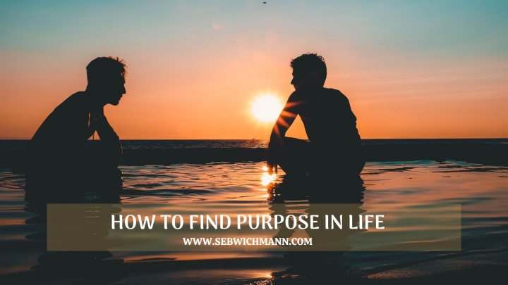 A man standing on a beach holding a surfboard - Howtofindyourpurpose