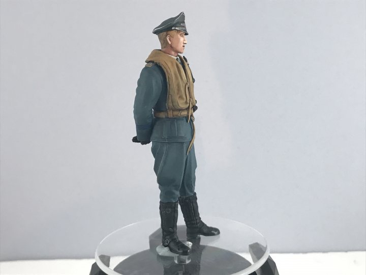 The thread where we can talk about painting figures. - Page 5 - Scale Models - PistonHeads - The image features a military action figure, which is displayed on a clear stand. The figure is of a soldier in full uniform, complete with a hat and boots. It appears to be a realistic representation of a serviceman in battle dress, possibly from World War II or another historical context. The figure itself has a detailed sculpture with shading and highlights that give it a lifelike appearance.