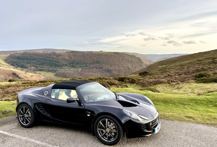 RE: Shrine-worthy superchargers | Six of the Best - Page 3 - General Gassing - PistonHeads UK - This image shows a luxurious sports car parked in an open area with a backdrop of hills or mountains. The car is sleek and modern, with its top down, revealing a convertible design. It appears to be a high-performance vehicle, as suggested by the aerodynamic shape and the prominent side vents. The setting suggests a rural or semi-rural location, given the presence of natural landscapes in the background.