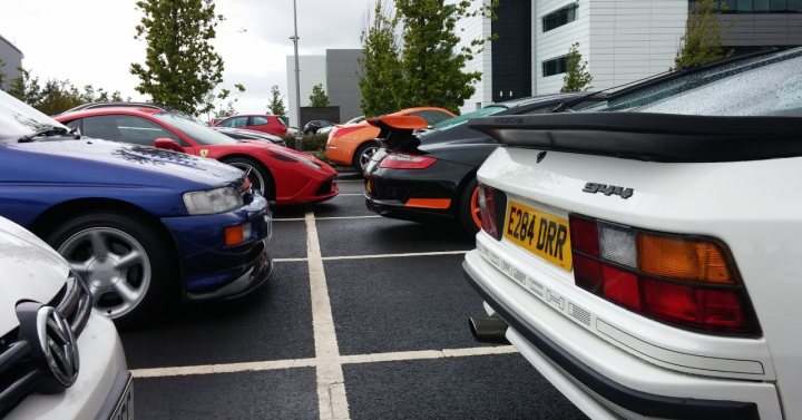 A police car parked on the side of the road - Pistonheads - The image depicts a parking lot filled with a multitude of colorful cars. The various types and sizes of vehicles suggest a public parking lot or possibly an event where people have gathered to park. The photograph captures the cars from a low angle, emphasizing their wheels and undersides. The presence of a sidewalk and a building suggests an urban setting. There is a comprehensive shoe care center right ahead.