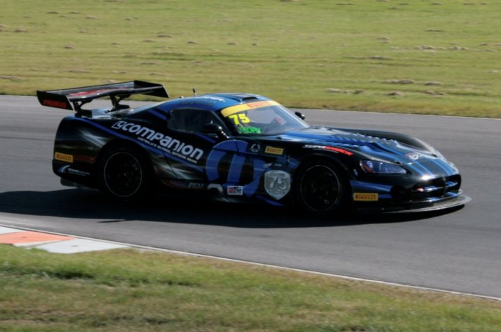 A blue car parked on the side of a road - Pistonheads - The image showcases a performance car skillfully navigating a sharp left turn on a racetrack. The car appears to be a sports prototype, with its bodywork featuring vibrant shades of blue and black, possibly representing a racing team's colors. The vehicle also sports the number 75, which might be referring to a driver or an event. The setting includes grassy embankments adjoining the track, adding to the thrill and intensity of the race. The reference to the "X-Comp Car" suggests that this car is part of a racing category or series, where the vehicles are often optimized for high speed and low weight.