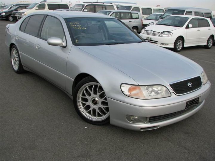 Obscure Performance Saloon Spin-offs e.g. Jetta 16v - Page 17 - General Gassing - PistonHeads - This image features a silver sedan parked in a large open parking lot. The vehicle appears to be well-maintained with chrome wheels. The parking lot is filled with other cars, highlighting the sedan's modern design. The lighting and shadows suggest it's daytime with ample sunlight. On the side of the frame, there's another car of a different color and model, adding variety to the scene.