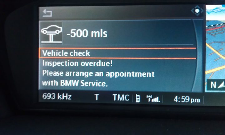 Can't reset the "inspection service" light (E61) - Page 1 - BMW General - PistonHeads - The image shows the digital display screen from a vehicle's navigation system. The screen is prominently displaying a warning for a 500ml vehicle check issue, notifying the user about an inspection overdue, with instructions to arrange an appointment with BMW service. The display screen also features a clock indicating the current time as 4:59 PM.