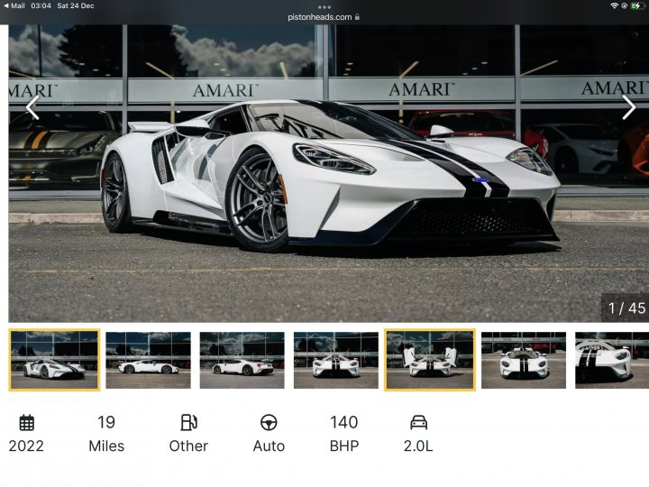 RE: Two-car dream garages | Six of the Best - Page 1 - General Gassing - PistonHeads UK - The image shows a screenshot of a digital photo album. At the center, there's an image of a sports car, specifically a Lamborghini Huracan, displayed in front of a store or garage with a visible Amari logo on its wall. The car is white and has distinctive design features such as angular headlights, vented side intakes, and a low-slung sporty stance. The interior of the vehicle is not clearly visible but appears to be well-appointed.

Above this main image, there's a user interface overlay that includes various icons and text typically found on a digital platform such as Facebook or Instagram. These elements suggest options for sharing, liking, commenting, and other typical social media actions. The screenshot also features a navigation bar at the bottom of the page with a series of thumbnails, each depicting different images from the album, which hints that this image is part of a larger collection or gallery.

The user interface elements are primarily in English, indicating that the platform is likely English-language based. The overall style of the image indicates it's a screenshot taken from a mobile device, as suggested by the battery icon and signal strength indicators at the top of the screen.