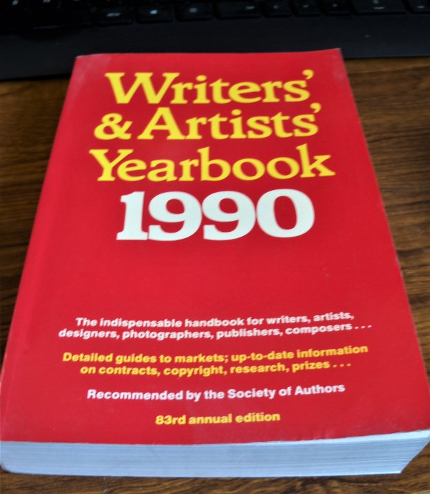 Anyone write books? - Page 1 - Books and Literature - PistonHeads - The image features a book with a predominantly red cover and yellow text. It is titled "Writers & Artists Yearbook 1990". The publisher, "The Writers Store", is also mentioned on the cover. A detailed description of the book's contents states that it includes an independent handbook for writers, designers, artists, photographers, publishers, composers, and computer professionals, as well as information about contracts and rights.