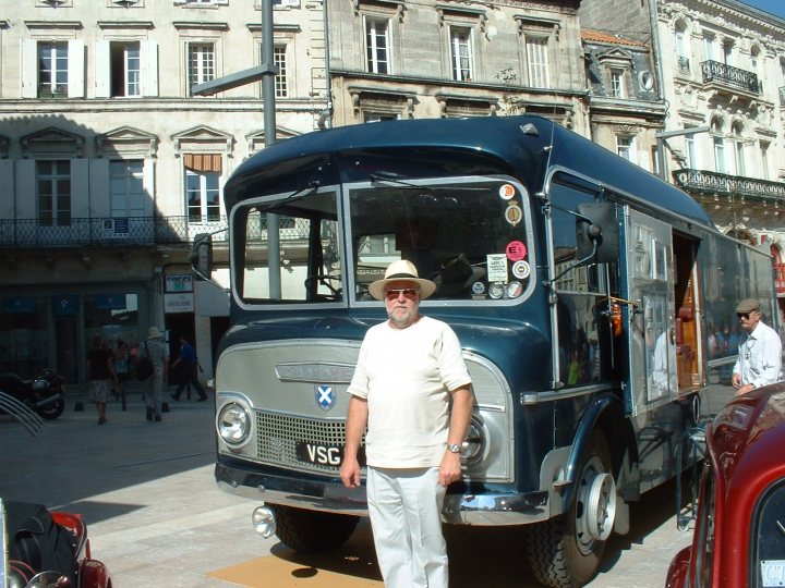 A man is standing in front of a bus - Pistonheads