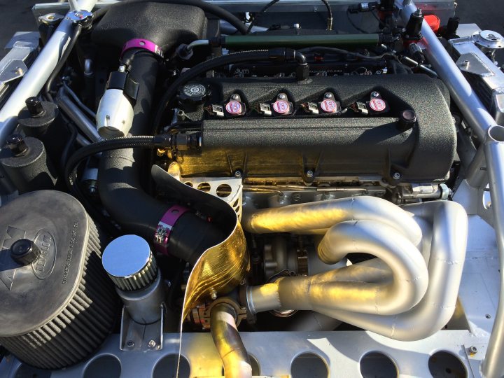 A close up of an old fashioned blender - Pistonheads - The image showcases an engine with a combination of black and gold color highlights. It's clear that this is a high-performance vehicle with various pipes and lines connecting the mechanical components. The design suggests customization with elements such as a purple idler pulley, adding a unique touch to the engine bay. The image provides a detailed view of the engine system, emphasizing its complexity and sophistication.