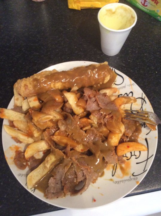 A white plate topped with a sandwich and fries - Pistonheads