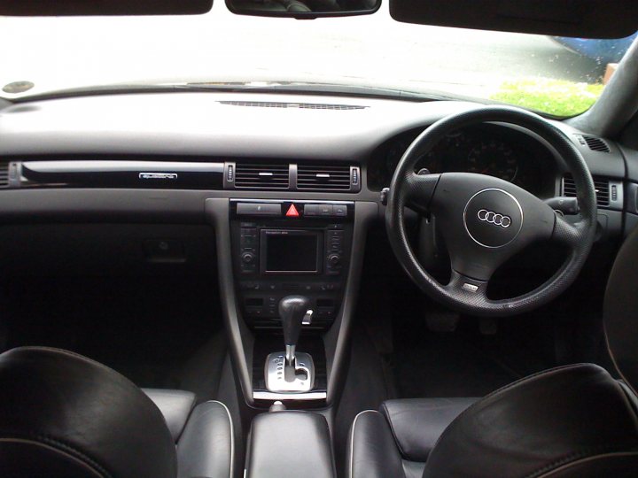 Pistonheads Mrc Dyno - The image presents a close-up view of the interior of a car, focusing on the driver's seat. The dashboard and center console are visible, with various controls and the car's automatic gearbox. The steering wheel, featuring the Audi emblem, is unoccupied and in the center of the steering wheel, the auto gearbox is clearly visible. The car's interior shines under the glare of the light, showcasing the cleanliness and smooth finish of the leather seats and other surfaces. The front seat is in a reclined position, suggesting that the car door is open.