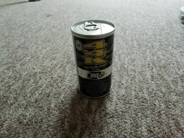 Fiesta St 180 - Page 5 - Readers' Cars - PistonHeads - This image shows a can of Monster Energy Drink placed upright on a carpeted floor. The can is silver and features the iconic Monster logo with a yellow number "1". There are texts such as "Monster Energy" and "Bang Energy" visible on the can, indicating its brand and flavor. The carpet appears to be a neutral color, providing a contrasting background for the can. The lighting in the image is even, suggesting an indoor environment with artificial lighting.