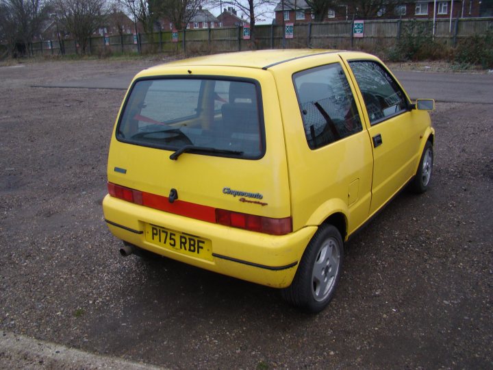 A yellow car is parked in a parking lot - Pistonheads