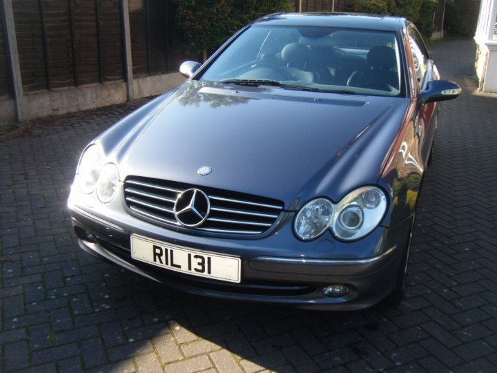 Best smoker barges 1-5 large [Vol 10] - Page 366 - General Gassing - PistonHeads - The image shows a dark blue, four-door Mercedes-Benz R-Class parked on a driveway overlaid with a pattern of light-colored bricks. The vehicle is positioned at a slight angle to the camera, with profiles of the front and side visible. The front bumper, grille, and headlights of the R-Class are clearly visible, featuring the Mercedes-Benz emblem and the registration plate. The scene appears to be a residential area, with a small section of a house visible in the background.