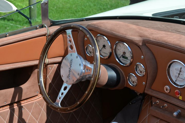 Spotted 2017 - Page 13 - North East - PistonHeads - The image showcases the interior of an old car, dominated by a classic steering wheel. The steering wheel has many smaller instruments circling it, each with its own gauge, enhancing the deluxe feeling of the car's interior. The dashboard and side panels are well-ventilated, indicating attention to both functionality and aesthetics. The combination of brown leather and shiny silver elements gives the car a sophisticated and vintage appearance.