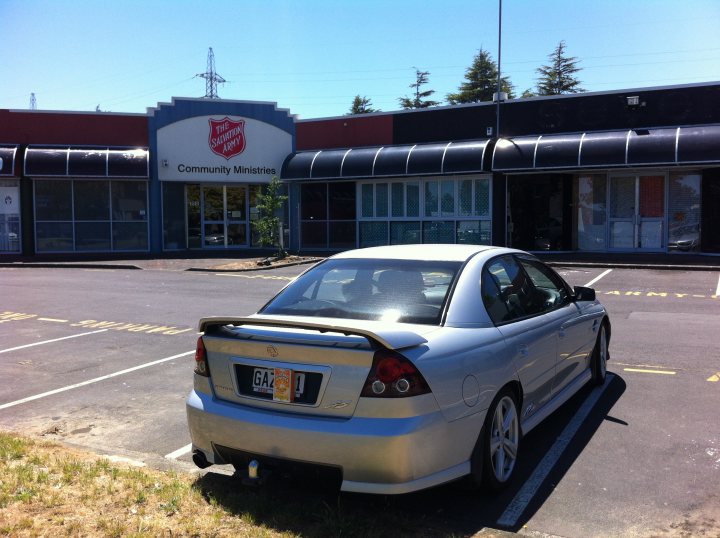 Lets play the Photo Location Game! - Page 502 - General Gassing - PistonHeads - The image features a silver sedan parked in the parking lot of a Community Ministry service center. The car is clean and positioned at an angle towards the camera. In the background, there's a building with a red and white sign that reads " Salvation Army Community Ministries." The sky is clear, suggesting it might be a sunny day. The parking lot appears to be well-maintained with visible white markings on the ground.