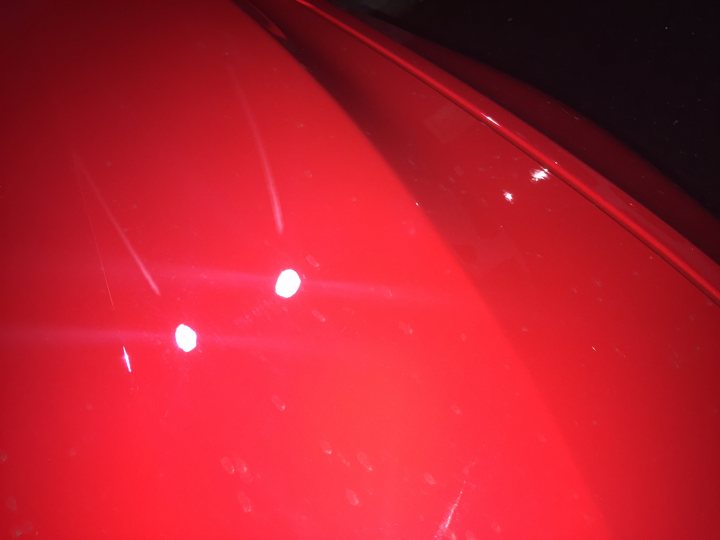 Shocking Scratches New M4 with individual Ferrari Red - Page 9 - General Gassing - PistonHeads - The image captures a close-up of a red car, focusing on its side. The car is red and appears to be a Ferrari, a luxury sports car manufacturer. The reflection of light on the car's body indicates it might be during daytime. The LED lights on the bodywork of the car are illuminated, providing a contrasting effect against the red of the vehicle.