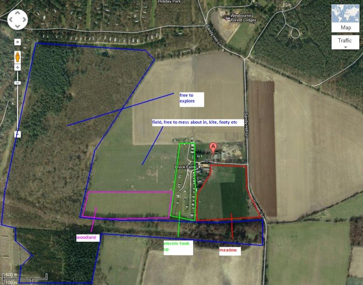 A sign that is on the side of a building - Pistonheads - The image shows a satellite view of a large, rectangular field with a Highway bypassing it on two sides. There are some wooded areas surrounding the field. The field is detailed, showcasing the layout with various dirt roads or paths of different lengths and colors. There's a prominent red dot highlighting an area within the field, labeled "FREE TO EXPLORE". A smaller up-close inset of the red-highlighted area shows it is near a structure, possibly a small house, with a separate outbuilding or barn. There are texts annotating specific locations within the field, including "LITTLETON PARK", "FREE TO EXPLORE", "VARIOUS DIRT, RAYLE ROADS & PATHS", "WOODS & ELECTRIC GROUND HERE!", "FREE LANE HERE!", and "MeADOW". The bottom of the inset contains annotations stating "SMALL HOUSE & STOVE, THEME TOWN, and THEME TOWN".