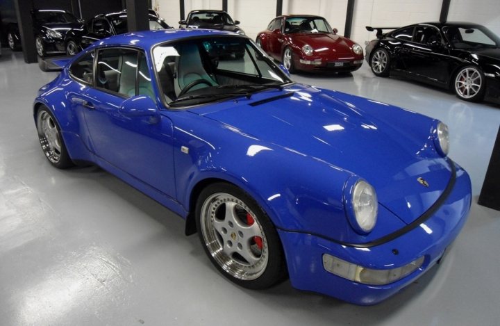 A blue car parked in front of a building - Pistonheads