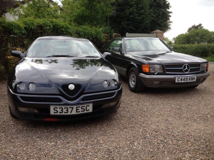 Best 2 Car Combos - Page 3 - General Gassing - PistonHeads - The image features two luxury cars parked in a driveway. The car on the left is a Silver Spider-Marina with a license plate reading "S337 ESC." The car on the right is a sleek black Mercedes C43 with a license plate reading "C446KH." Both vehicles are elegant and polished, suggesting new or well-maintained. The environment around the cars is serene, with lush green bushes and a clear sky in the backdrop. The setting seems to be a quiet residential area.