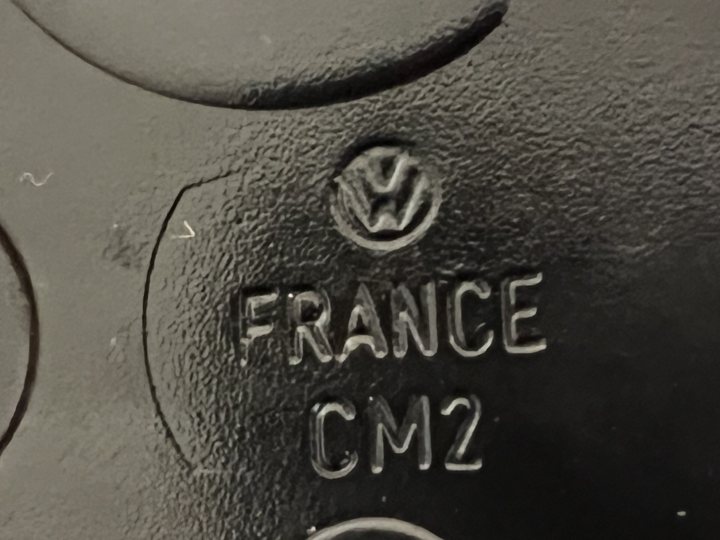 1998 996 C2 - Page 53 - Readers' Cars - PistonHeads UK - The image shows a close-up of a vehicle part with text and logos. At the top, there is an automobile emblem with the word "FRANCE" beneath it, suggesting this may be a French brand or part. Below that, the text reads "France" followed by a model name or number "C2 M1." The background appears to be a darker shade of black, possibly metal, and the focus is on the textual information rather than the environment. The style of the image seems to be a casual photograph with no professional composition or lighting.