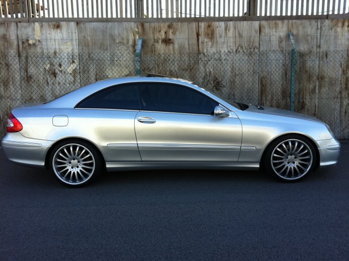 Mercedes Pistonheads - The image displays a silver car parked outdoors. The vehicle looks clean and well-maintained. The car is positioned perpendicular to a fence, which is visible in the background. There is no distinct license plate on the back of the car. The style of the car is sleek and modern, with a glossy finish on the paint.