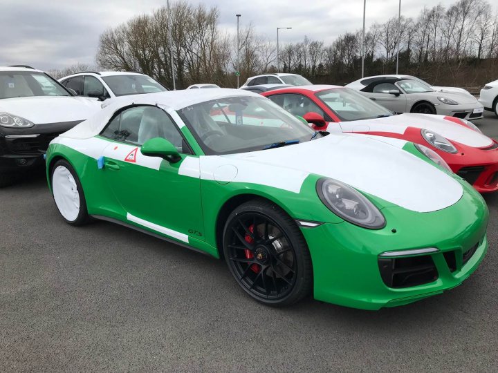 991 GTS Must haves - Page 176 - 911/Carrera GT - PistonHeads - This image features a parking lot where various sports cars are parked. There is a predominantly white Porsche and a green Porsche in the foreground. Behind these, there is a red Porsche and a trio of silver luxury cars. This suggests a high-end car show or a luxury car dealership. The scene captures a moment of quiet luxury displayed outdoors.