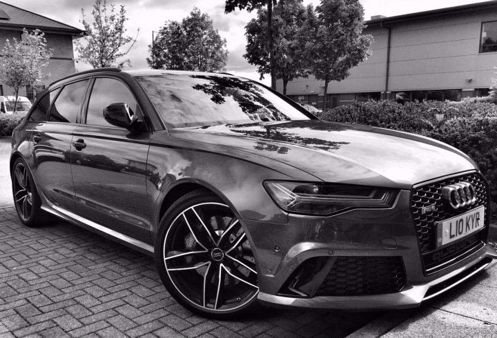 A black and white photo of a car parked in a parking lot - Pistonheads