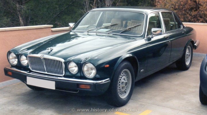 Your favourite car from the year you were born in... - Page 12 - General Gassing - PistonHeads - The image shows a classic British sedan parked on a driveway. The car is a four-door model, painted a glossy dark green, which gives the car a vintage appearance. The vehicle features wire-spoked wheels, headlamps, and a radiator grille that are characteristic of British car design from the mid-20th century. The car is parked next to a fence, and there is another vehicle in the background.