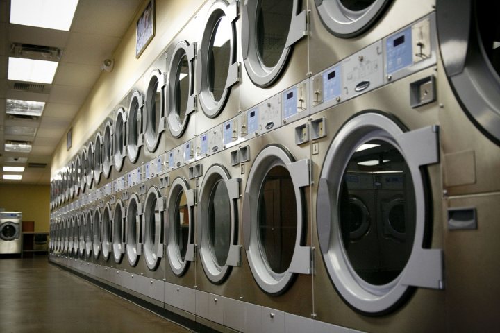 How do exotic care rental firms make any money? - Page 1 - General Gassing - PistonHeads - The image presents a commercial laundry facility where a row of industrial washers is arranged side by side. The washers vary in size and color, suggesting different options for load capacity and machine type. The surroundings are clean and brightly lit, with a large, bare wall located behind the washers. On the left side of the image, there is a partial view of an air conditioning unit, indicating an effort to regulate the temperature in the room.