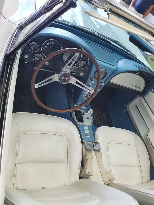 Lets see your Yank tanks! - Page 53 - Yank Motors - PistonHeads UK - The image displays an interior view of a classic muscle car with a blue and white color scheme. The car's dashboard is prominently visible, featuring a steering wheel with chrome details and an array of gauges. The upholstery appears to be in good condition, indicating that the car may be well-maintained or restored. The front passenger door is open, revealing the vehicle's interior. This image captures the elegance and charm of classic automobiles, highlighting the craftsmanship and design aesthetics from a bygone era.