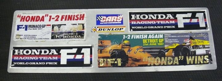 Show Us Your Stickers! - Page 1 - Formula 1 - PistonHeads - The image showcases a collection of Honda racing stickers and patches. At the heart of the collection is a Honda F1 car, with stickers adorned with a driver as well as the text "Honda Monaco GP" and "Honda F1 Racers". The stickers are unique, featuring different editions, and ominously, each one bears the warning label "F1 Monaco GP Honda patches". The display of these memorabilia items offers a glimpse into the fan's enthusiasm for Honda's performance in Formula 1 racing, particularly in the prestigious Monaco Grand Prix.